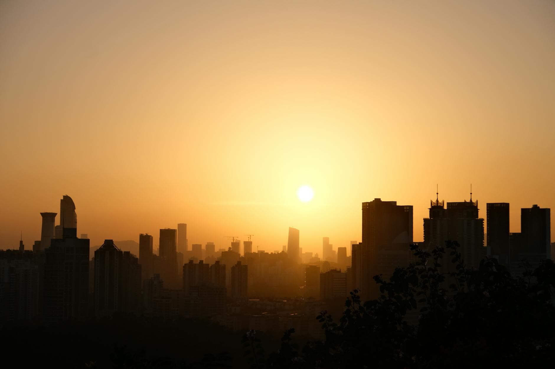 A breathtaking silhouette of a city skyline at sunrise, capturing the glowing horizon in China.