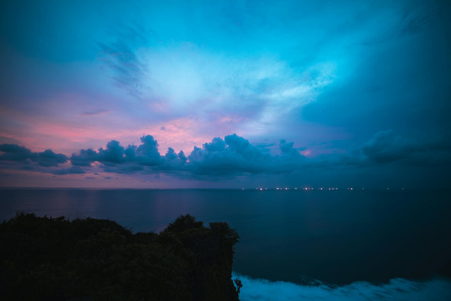 Experience the serene twilight sky over Bali's coastline, capturing a stunning blend of colors and peaceful ocean views.