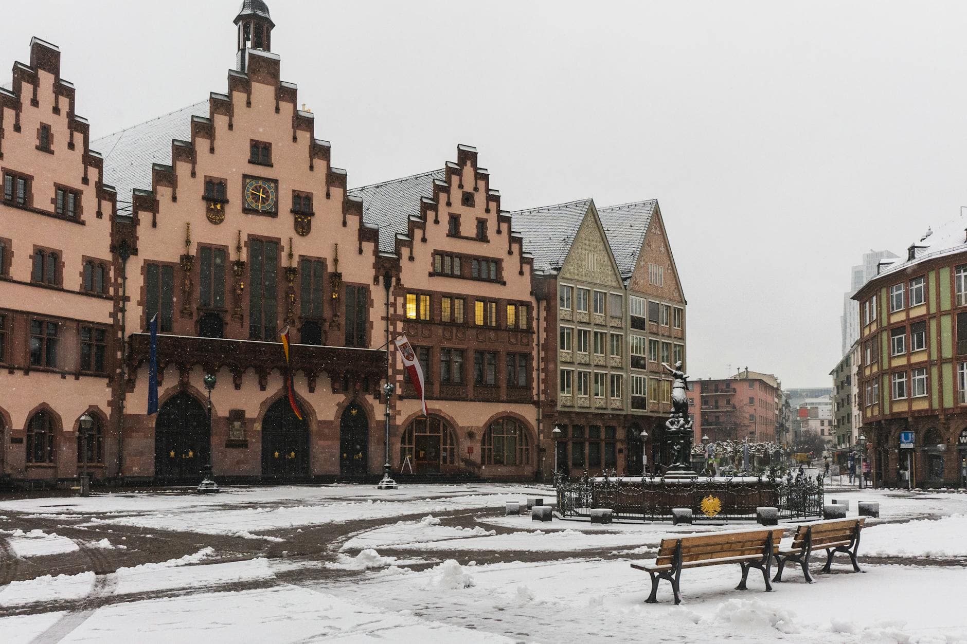 Snow-covered Römer Square in Frankfurt, showcasing historic architecture and a peaceful winter scene.